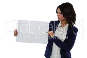 Businesswoman looking at placard