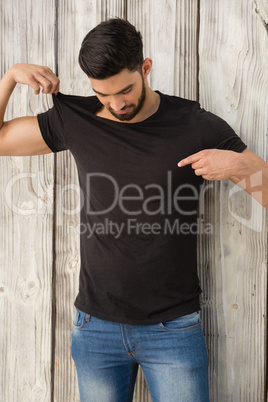 Handsome man pointing at t-shirt