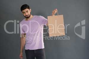 Portrait of man holding shopping bag
