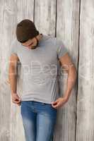 Handsome man posing against wooden background