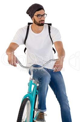 Man posing with bicycle against white background