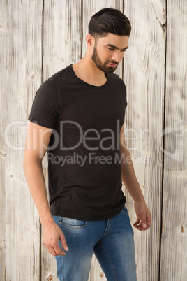 Man posing against wooden background