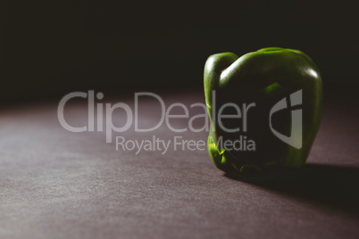 Carved green bell pepper on wooden table
