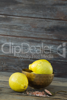 Lemon and himalayan salt on wooden table
