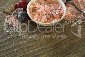 Himalayan salt with spices on wooden table