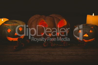 Illuminated jack o lantern with candles on table during Halloween