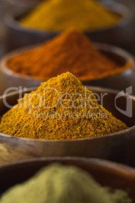 Various spice powder on wooden table