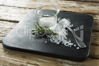 Salt in glass bowl and rosemary herb