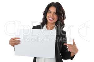 Portrait of smiling businesswoman pointing at placard