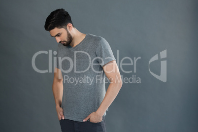 Handsome man posing against grey background