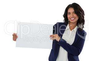Portrait of smiling businesswoman holding placard