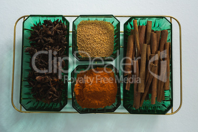 Anise and cinnamon with spices powder in tray