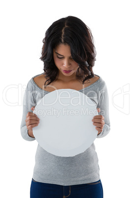 Woman holding circle shaped placard