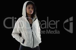 Thoughtful female athlete in hooded jacket