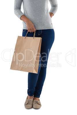 Woman holding shopping bag against white background