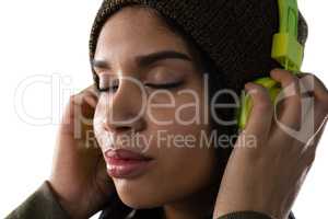 Close up of woman listening music on headphones