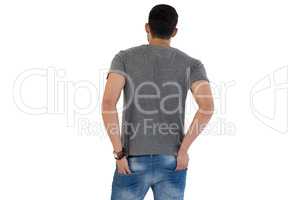 Rear view of man standing with hands in pocket