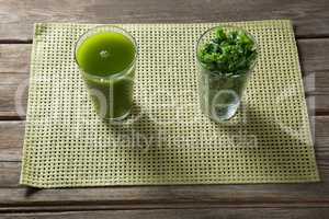 High angle view of kale juice and leaves in glasses