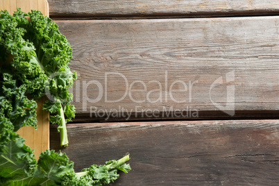 Fresh kale leaves on wooden board
