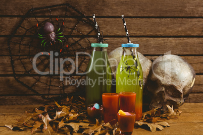 Drinks with decorations and autumn leaves on table