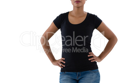 Mid section of woman standing with hands on hip