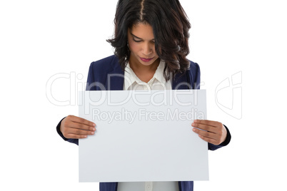 Young businesswoman holding placard
