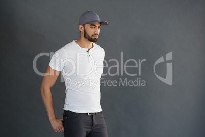 Handsome man posing against grey background