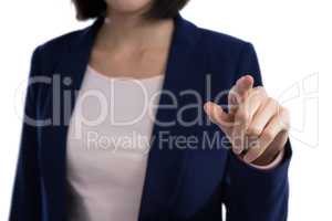 Mid section of businesswoman touching invisible screen