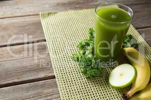 Fresh kale juice in glass with fruits