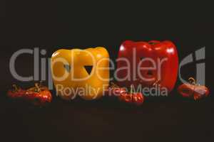 Carved bell peppers with small pumpkins over white background