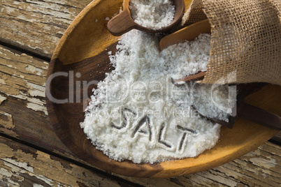 Word salt on wooden plate