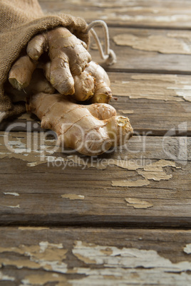 High angle view of gingers in burlap sack on weathered table