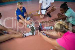 Volleyball players performing stretching exercise