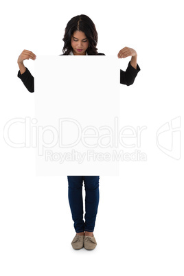 Young businesswoman holding blank placard