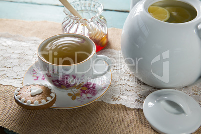 Ginger tea cup with honey on burlap