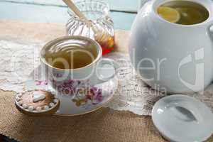 Ginger tea cup with honey on burlap