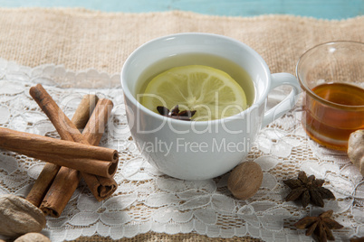 Ginger tea with cinnamons and honey on burlap