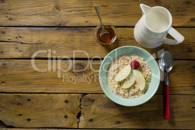Fruit cereal and milk on wooden table