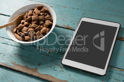 Bowl of chocolate toast crunchs with digital tablet