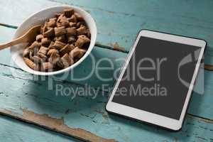 Bowl of chocolate toast crunchs with digital tablet