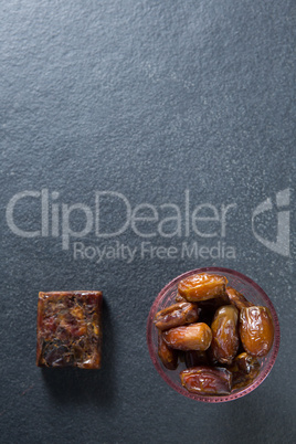 Overhead view of dates fruits in bowl on slate