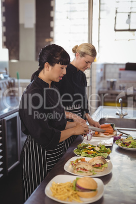 Female chefs preparing food in kitchen