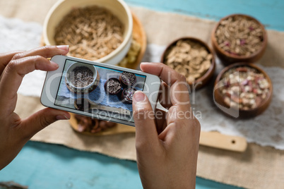 Hands taking photo of breakfast with mobile phone