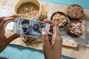 Hands taking photo of breakfast with mobile phone