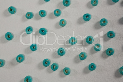Froot loops arranged on white background