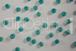 Froot loops arranged on white background