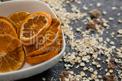 Bowl of dried orange slices and breakfast cereals