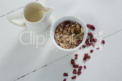 Bowl of breakfast cereals with dried fruits and jug