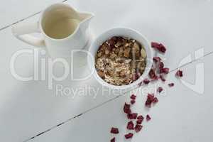 Bowl of breakfast cereals with dried fruits and jug