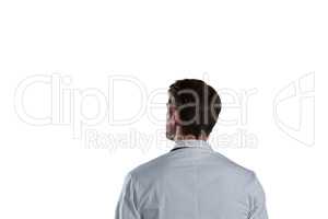 Rear view of male doctor standing against white background